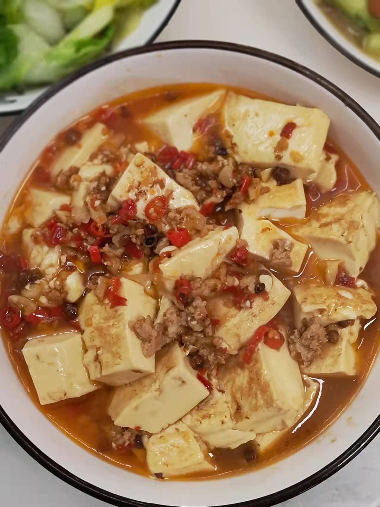 Salted egg mapo tofu with pork, chiles, and Sichuan peppercorns